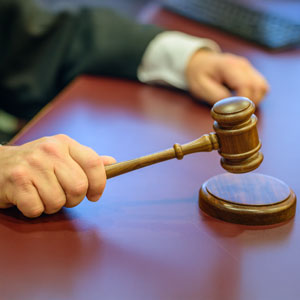 Close-up of a judge using a gavel, symbolizing the enforcement of Sentencing Guidelines in a courtroom